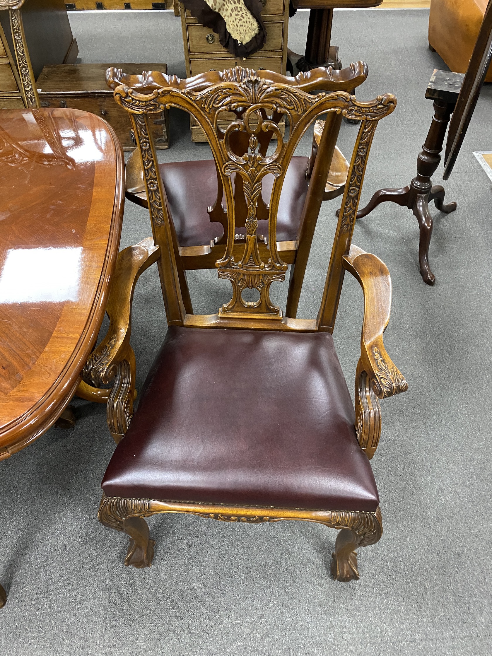 A reproduction inlaid mahogany twin pillar extending dining table, approx. 250cm extended, two spare leaves, width 110cm, height 75cm, together with eight Chippendale style mahogany dining chairs, two with arms